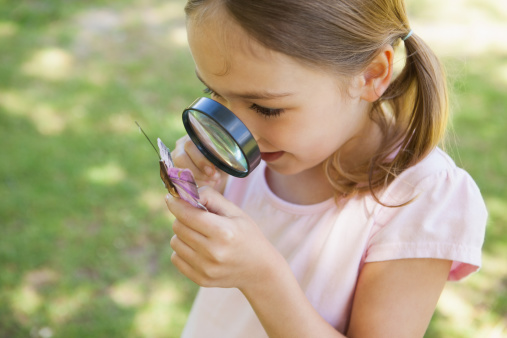 A picture of a student with a magnifying glass